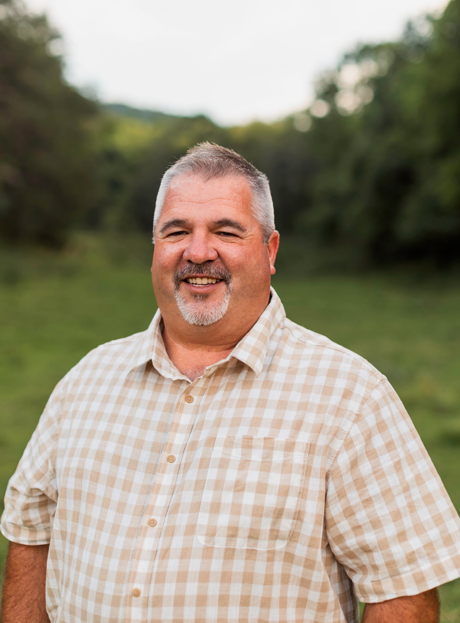 JD Estep smiling outdoors in Claiborne County